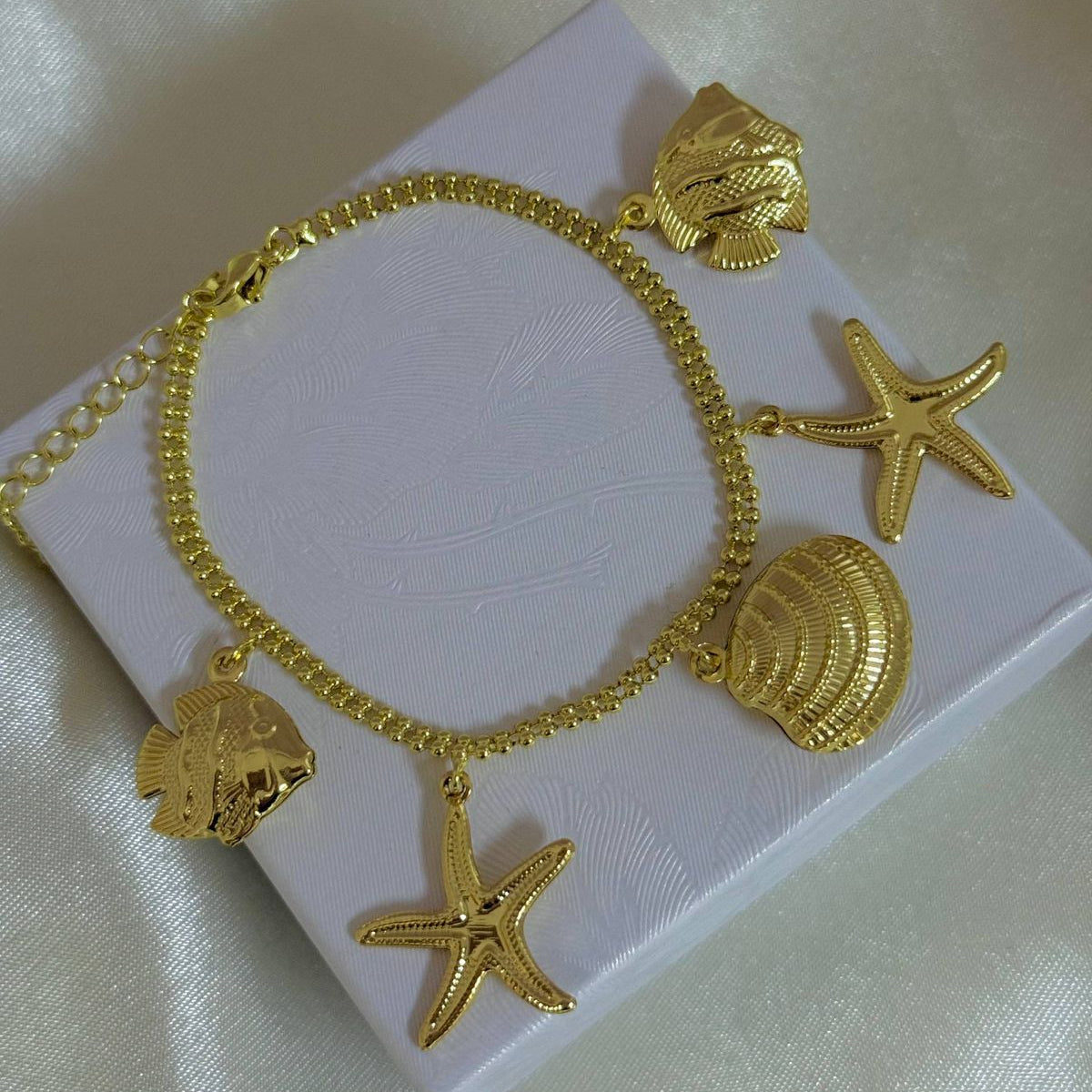 Pulseras playeras material oro Golfield